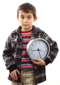 Portrait of a schoolboy with a clock. Time to school concept 