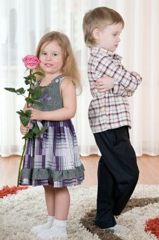 The little boy gives to the girl a  flowers