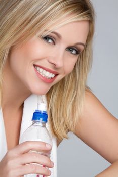 Smiling woman holding water bottle