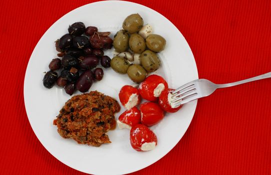 greek olives, Tapenade and sweet pepper with cheese on the plate