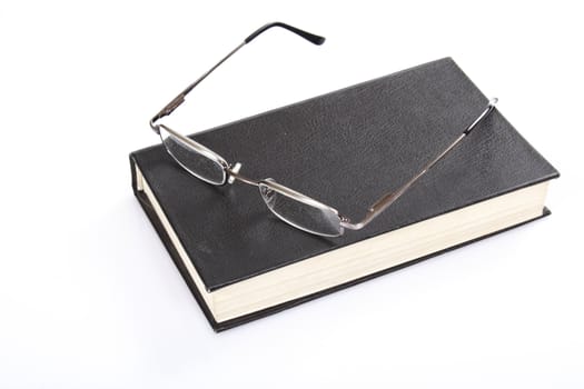 glasses and book photo on the white background