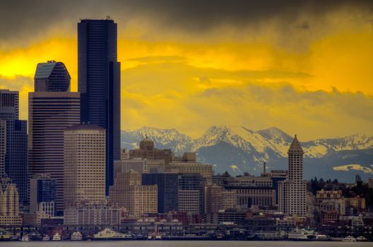 Downtown Seattle with dramatic sky and Cascade Mountains in the background