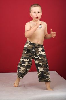 Boy sings boy in military trousers party