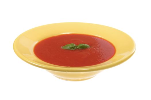 tomato soup in yellow plate, photo on white