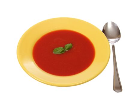 tomato soup in yellow plate, photo on white
