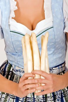 Bavarian Woman with asparagus in front of the chest