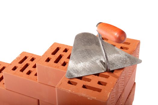 red bricks and trowel, photo on the white background 