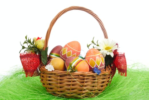 Easter eggs in basket on green Grass