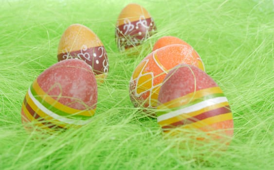 Painted brown Easter Eggs on green Grass
