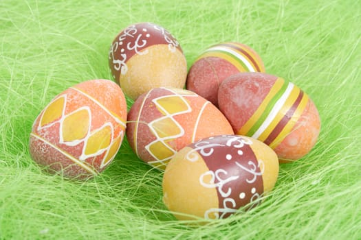 Painted brown Easter Eggs on green Grass