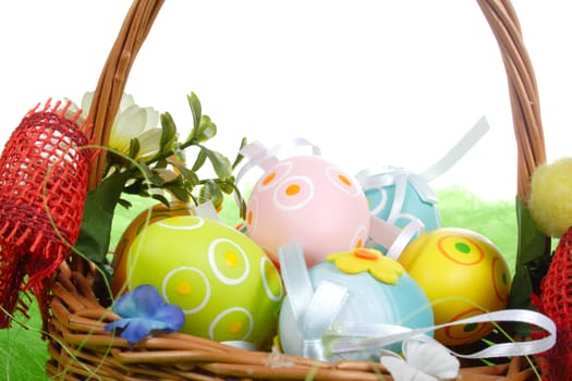 Easter eggs in basket on green Grass