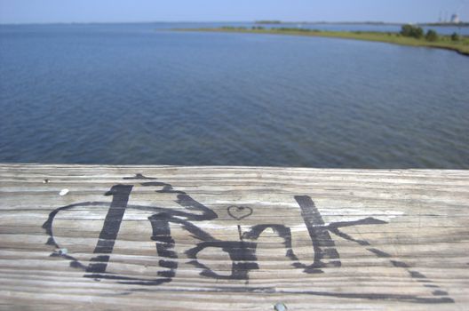 Graffiti on wood boardwalk on the ocean