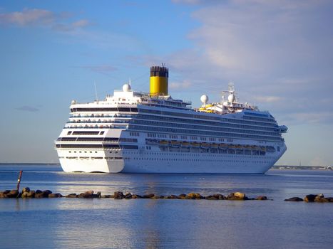 white cruise ship getting out of port