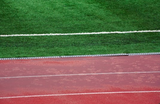 Rain before match Marsielle vs Legia. Wet field and athletic track.