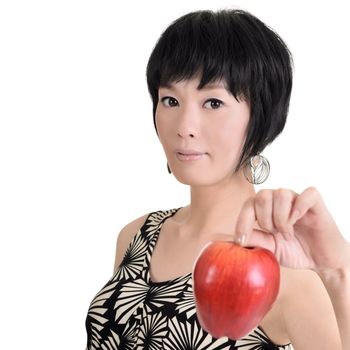Woman holding red apple and looking at you, half length closeup portrait on white background.