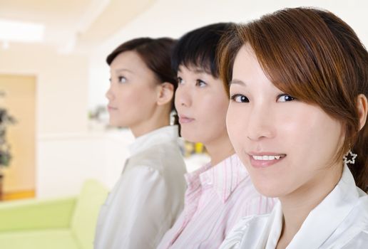 Young business woman in office environment, half length closeup portrait inside of modern buildings.