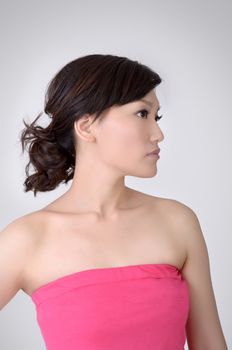 Asian beauty, half length closeup portrait on studio gray background.