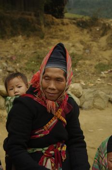 Phu La ethnic woman and her headdress characteristic. The temperature has dropped for some time. It's cold in the mountains so she put this scarf to protect his ears.
