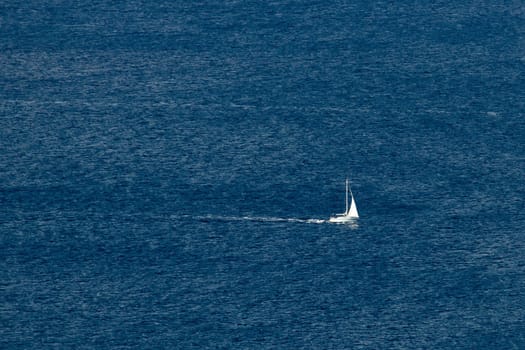 Sailboat on open sea, blue waters