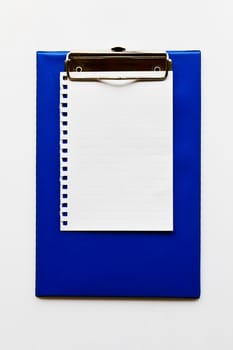 Blank notepaper on a  blue clipboard background.