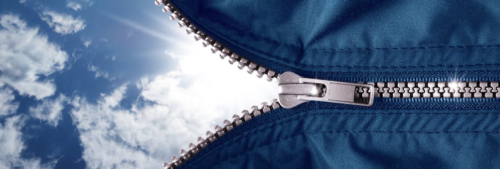opened zipper with blue sky