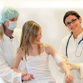 Doctors and nurses join an injured child - all while smiling-Square