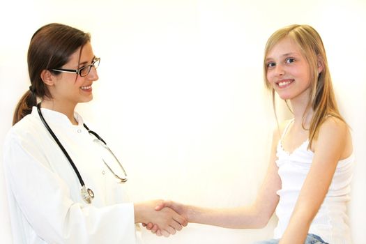 Girl with doctor shaking hands - both smiling-Copy Space and white background