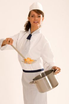 female cook in saucepan with work clothes and chanterelles
