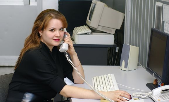 business woman speaks over telephone 