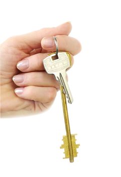  bunch of keys hangs on finger of woman hand