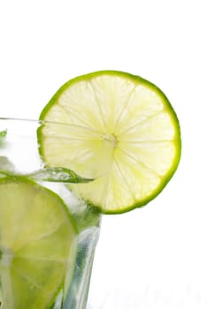 Green mojito with a slice of lime isolated on white