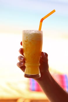 Glass Of Tasty Yellow Refreshment Drink Held On Hand