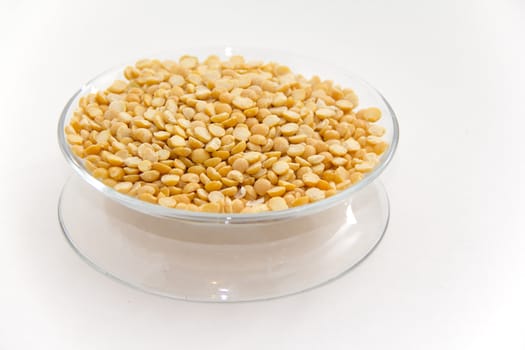 Yellow split peas on a clear plate with with background