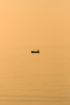 Fishing boat in the evening sun on the beach in front of Supetar on the island of Brac in Croatia