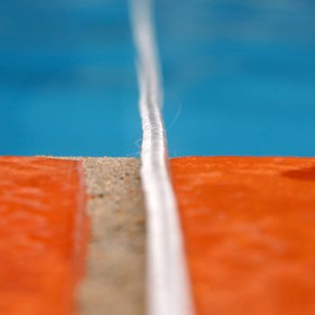 Summer concept background. White rope over swimming pool border.