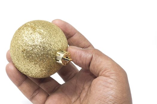 A beautiful sparkling christmas ball delicately held by hand