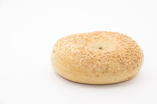 A sesame seed bagel on a white background