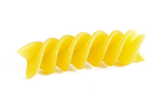 A colorful yellow raw fusilli on a white background