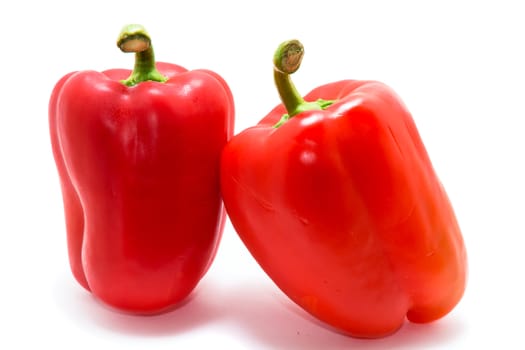 Two red bell peppesr isolated on a white background