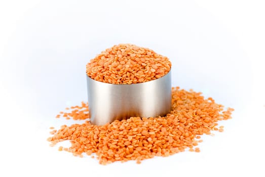 orange lentil in a metal cup
