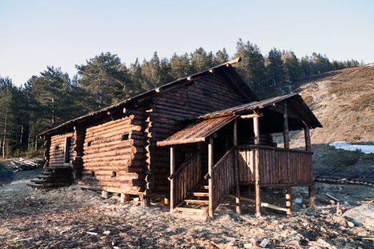 Wooden house in the medieval style on the background of the forest