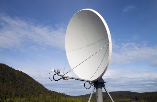 A satellite dish on the background of nature