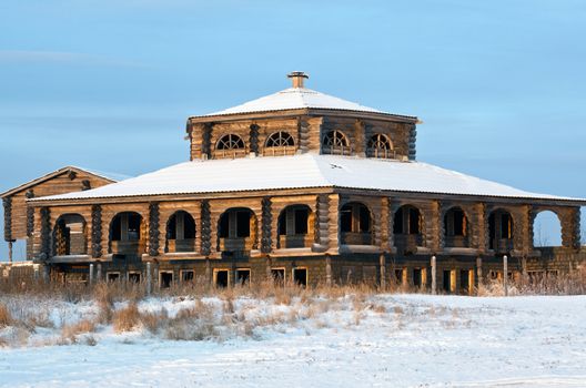 Building old-style against the blue sky. Winter