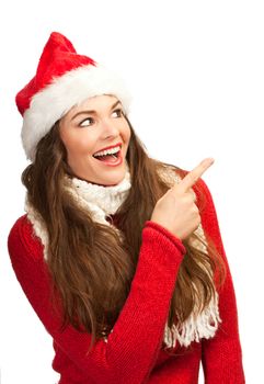 Beautiful young woman in santa hat pointing to copy space. Isolated on white.