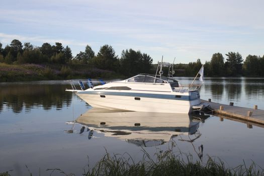 White boat on the dock. Evening Landscape