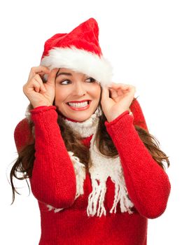 An attractive young woman smiling and peeking out from a santa hat. Isolated on white.