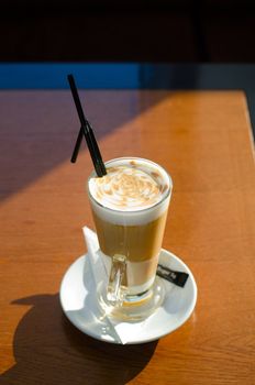 Latte coffee cup closeup at the table