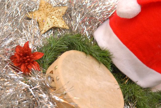 santa claus hat, tambourine and Christmas decorations