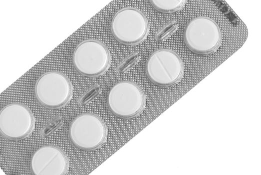 Macro view of white pills on blue background.