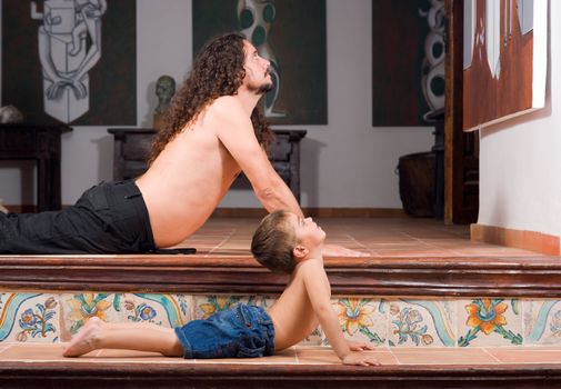 Father and son doing yoga exercises together